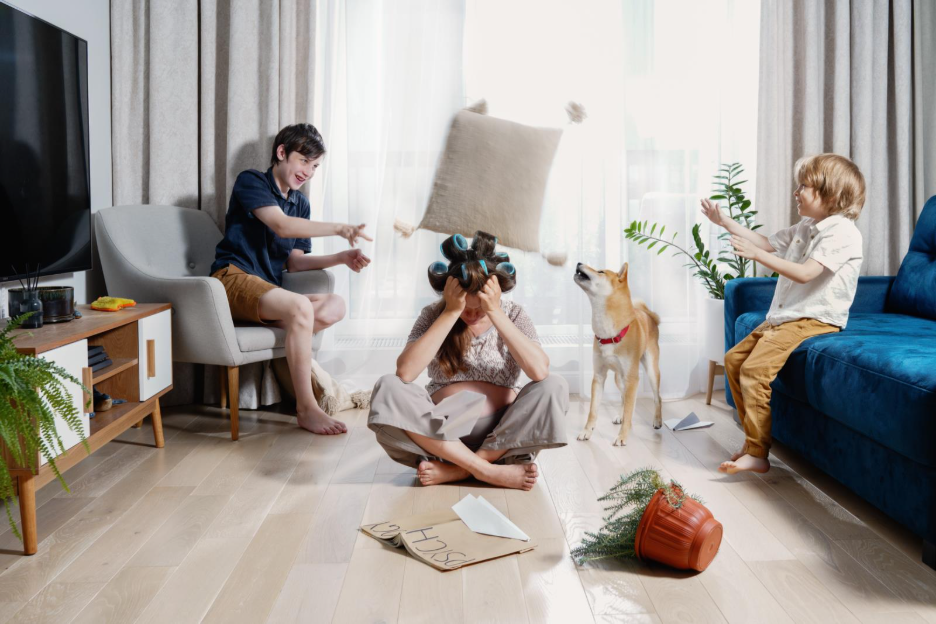 A woman in curlers with her kids being disruptive and loud in the house.